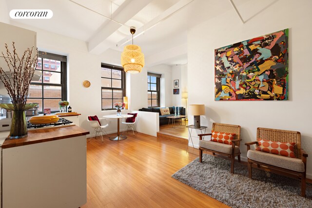 sitting room with visible vents, plenty of natural light, and wood finished floors