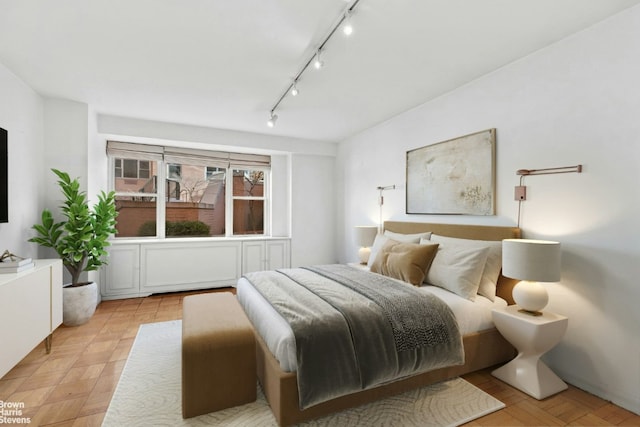 bedroom featuring rail lighting