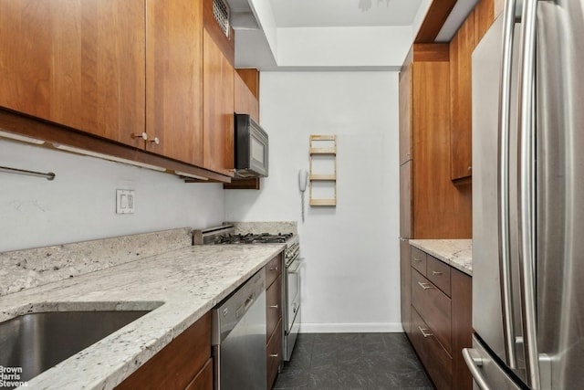 kitchen featuring light stone counters and appliances with stainless steel finishes