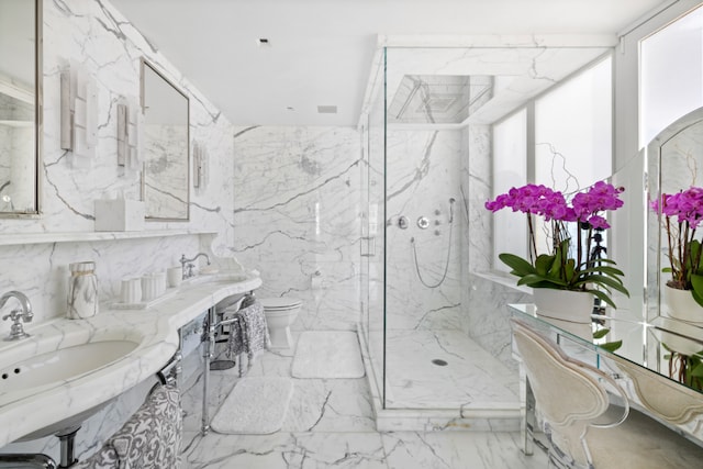 bathroom featuring marble finish floor, a marble finish shower, and stone wall