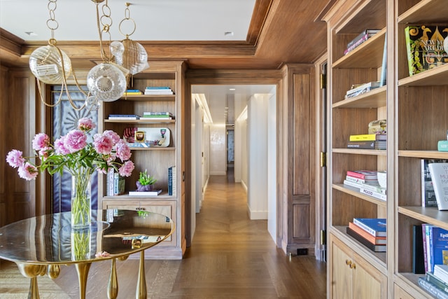 hallway featuring dark wood-type flooring and built in features