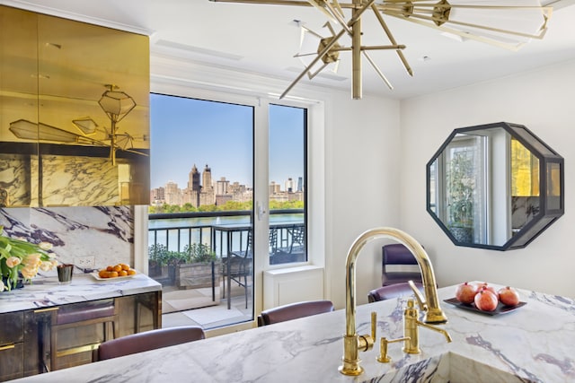 dining space featuring a water view and a city view