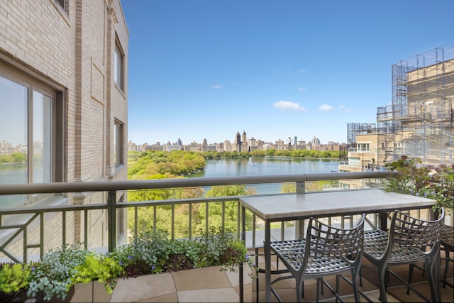 balcony featuring a view of city and a water view