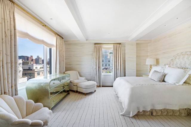 bedroom featuring a view of city, beamed ceiling, and wood finished floors