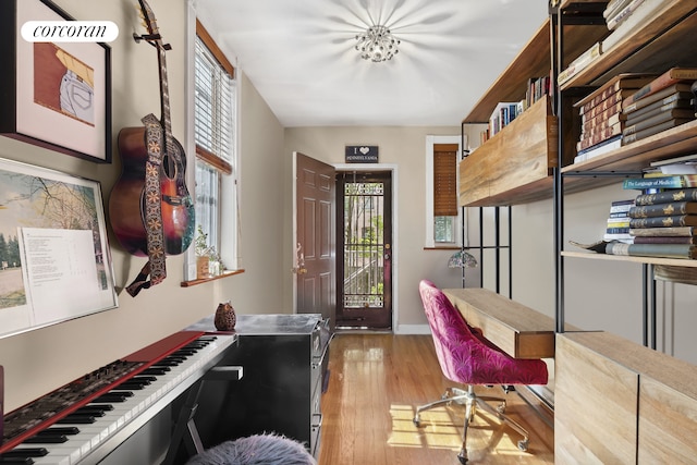 office area with baseboards, light wood-type flooring, and a wealth of natural light