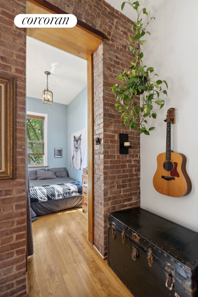 bedroom with wood finished floors and a chandelier