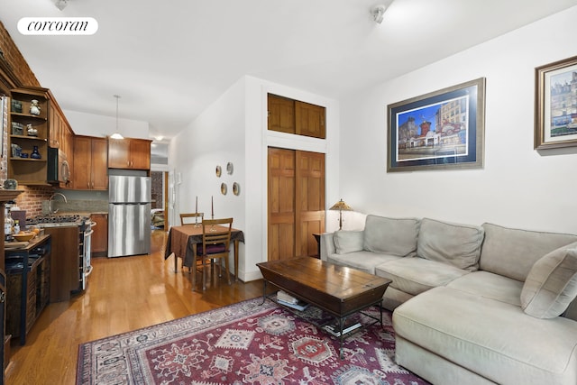 living room with visible vents and light wood-style flooring