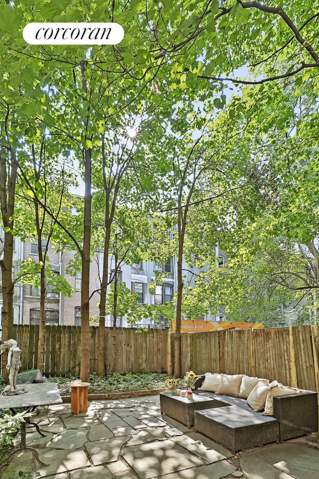 view of patio featuring an outdoor living space and fence