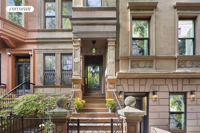 view of exterior entry featuring fence