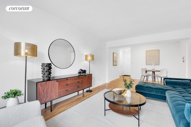 living room featuring light wood-style floors and visible vents