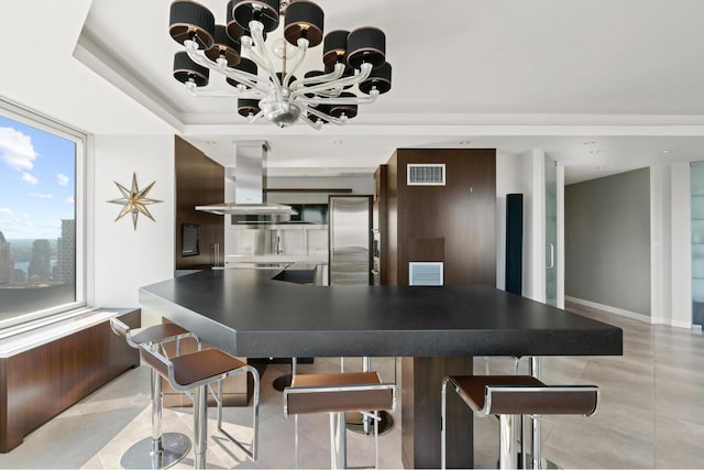 dining room with an inviting chandelier and a tray ceiling