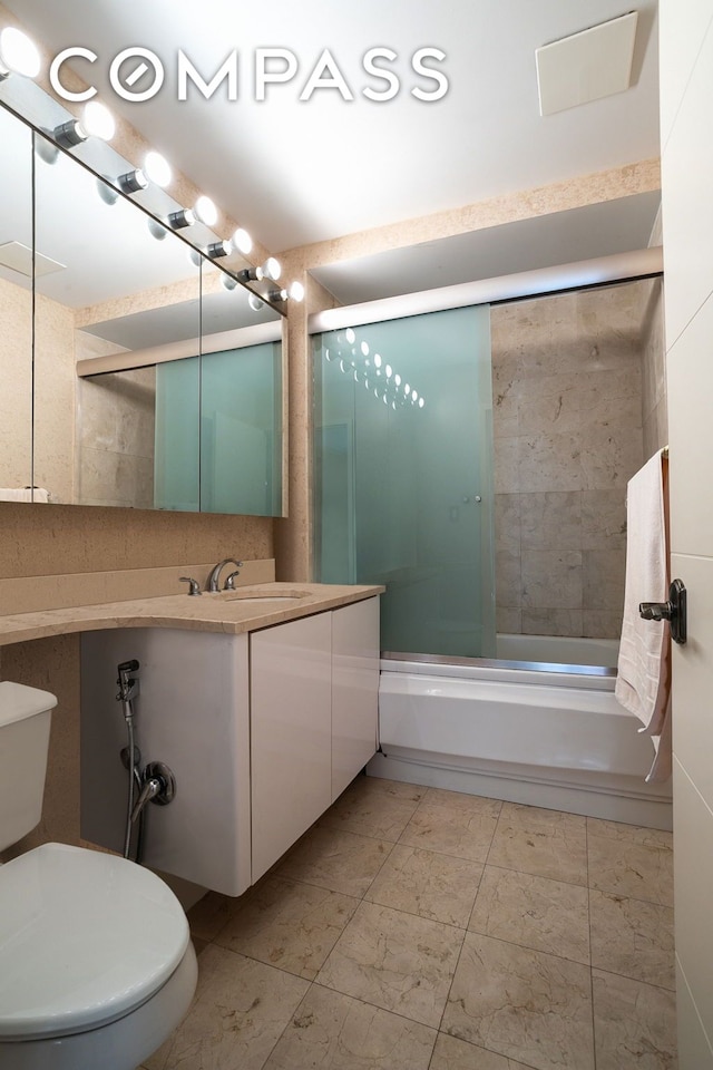 full bath with enclosed tub / shower combo, toilet, and vanity