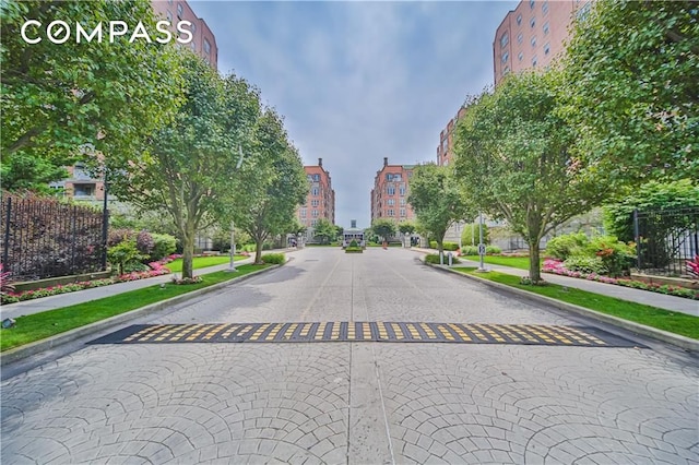 view of road featuring a city view, curbs, and sidewalks