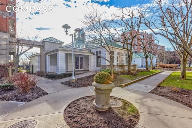 135 Oceana Dr E Unit 2C, New York City, NY 11235 - view of front of home with a standing seam roof, metal roof, and french doors