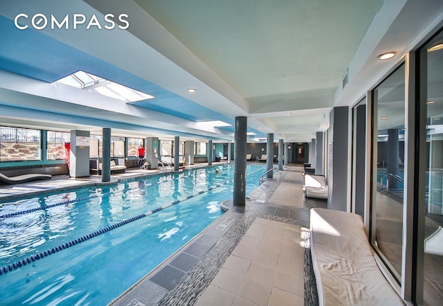 indoor community pool with a skylight