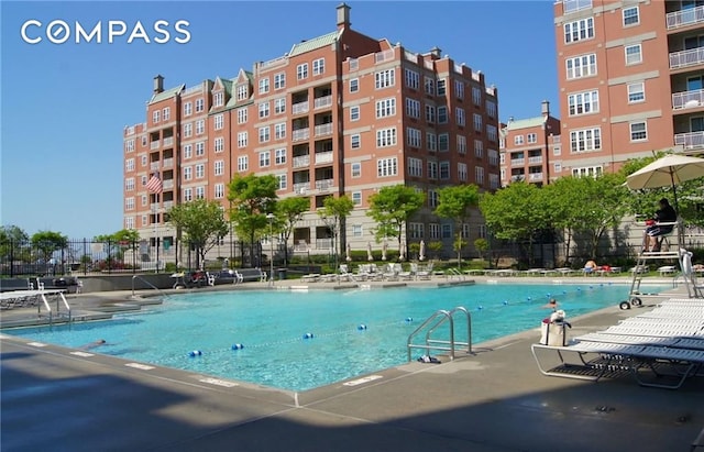 view of pool featuring fence