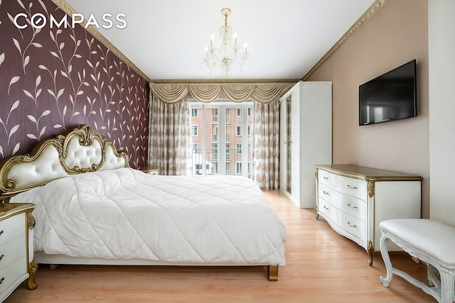 bedroom featuring a chandelier and light wood-style floors