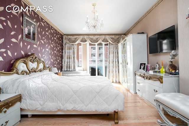 bedroom featuring wood finished floors, a chandelier, ornamental molding, and wallpapered walls