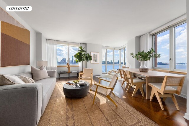 sunroom featuring a water view