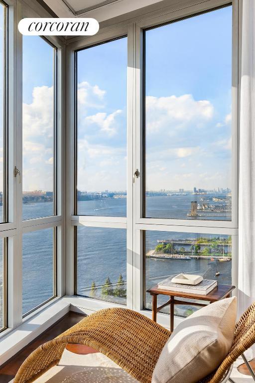 sunroom / solarium with a water view