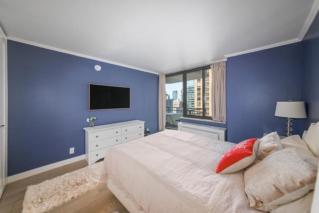 bedroom featuring ornamental molding and light wood-type flooring