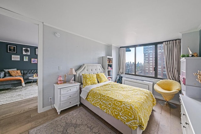 bedroom featuring crown molding and hardwood / wood-style flooring