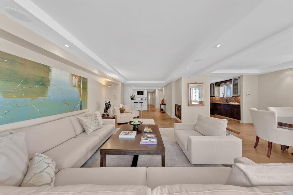 45 Sutton Pl S Unit 19A, New York City, NY 10022 - living area featuring light wood finished floors, a raised ceiling, and recessed lighting
