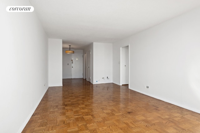 spare room with dark parquet floors