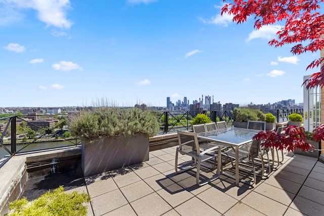 view of patio / terrace with a view of city and outdoor dining area