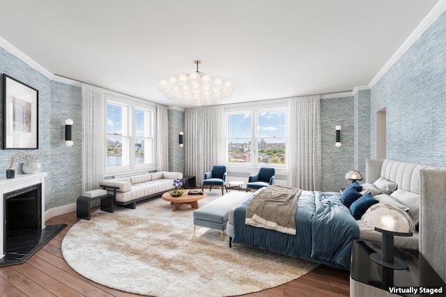 bedroom featuring an inviting chandelier, ornamental molding, and wood-type flooring