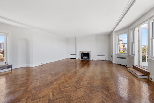 unfurnished living room with dark parquet flooring and radiator