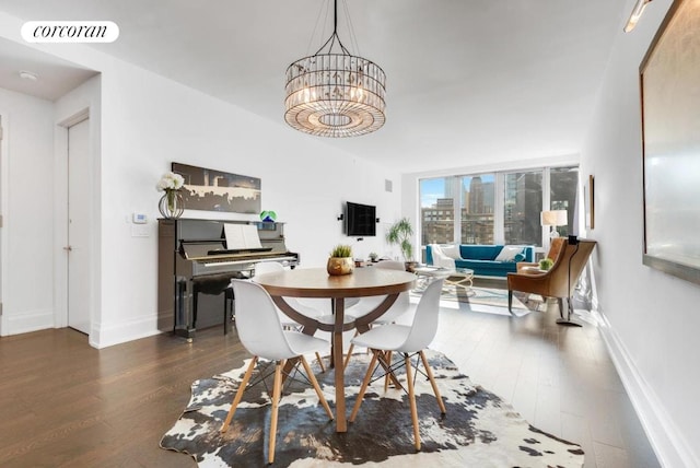 dining room featuring dark hardwood / wood-style flooring and a notable chandelier