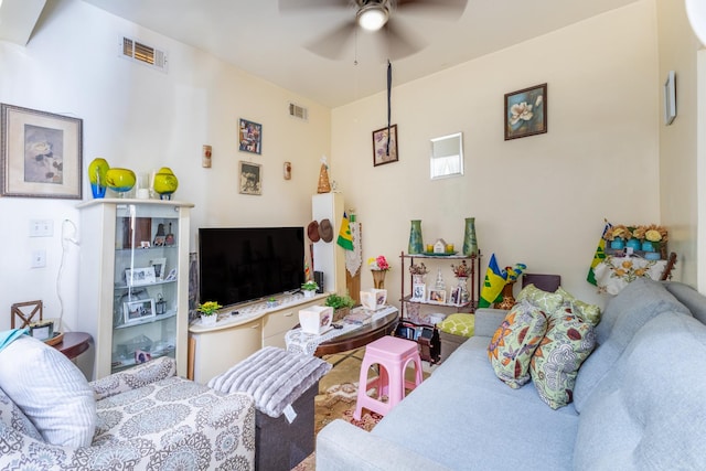 living area featuring ceiling fan and visible vents