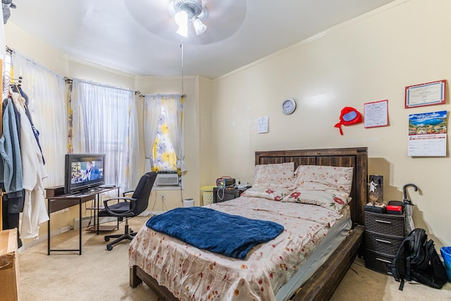 carpeted bedroom featuring ceiling fan and ornamental molding