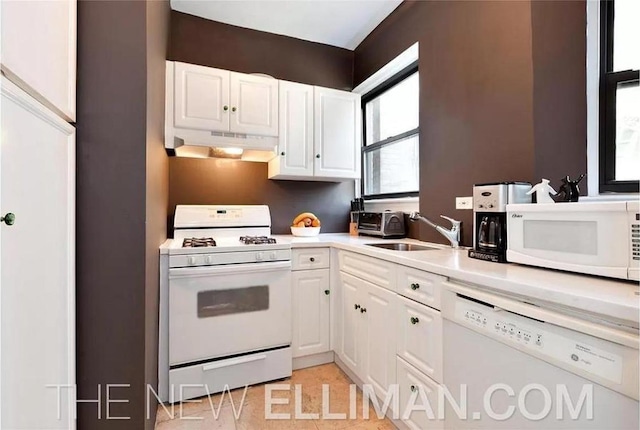 kitchen featuring white cabinetry, sink, white appliances, and light tile patterned floors