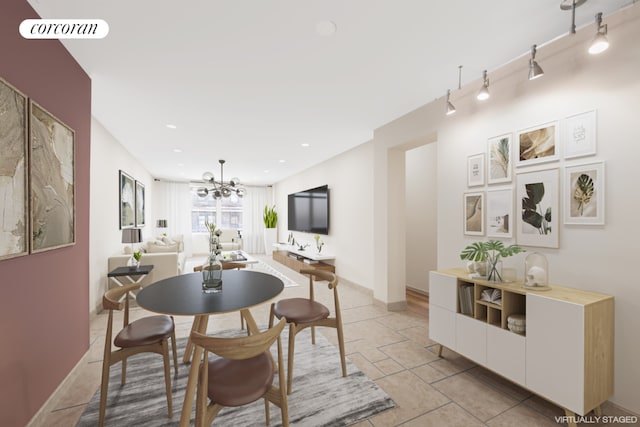 dining area featuring track lighting and an inviting chandelier