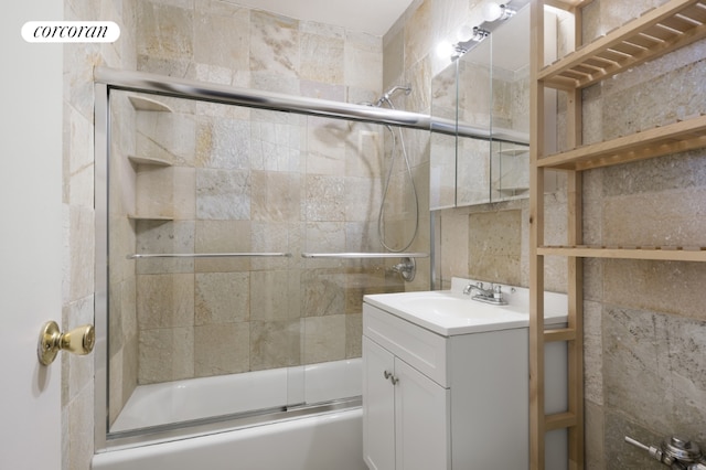 full bathroom featuring vanity and bath / shower combo with glass door