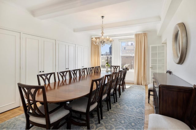 dining space with a chandelier, light parquet floors, and beamed ceiling