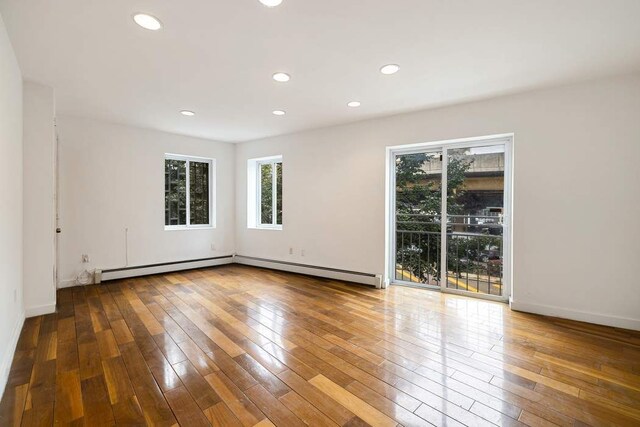 unfurnished room with hardwood / wood-style floors