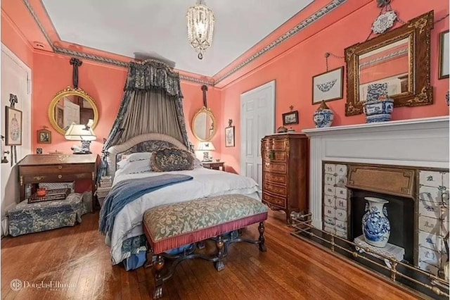 bedroom with crown molding and hardwood / wood-style flooring