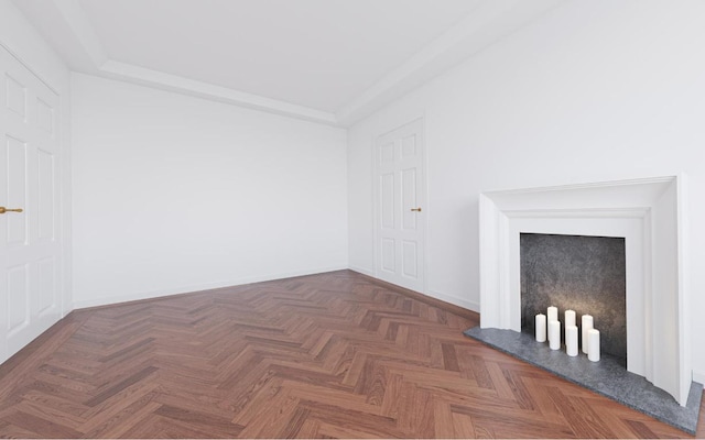 unfurnished living room featuring dark parquet flooring