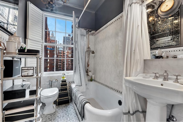 full bathroom with toilet, sink, shower / tub combo, tile walls, and backsplash