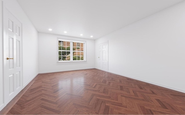 unfurnished room with dark parquet flooring