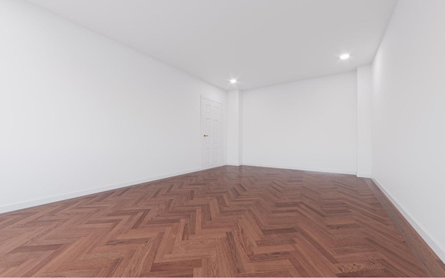 unfurnished room featuring dark parquet floors