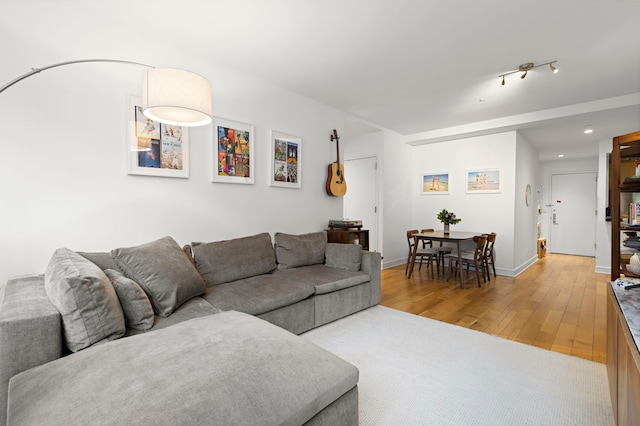 living area featuring light wood-type flooring and baseboards