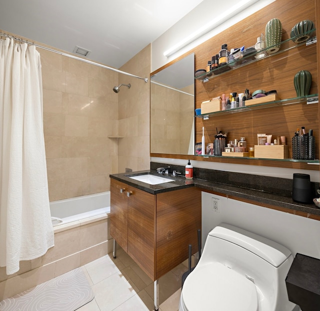 bathroom with visible vents, toilet, tiled shower / bath combo, vanity, and tile patterned flooring