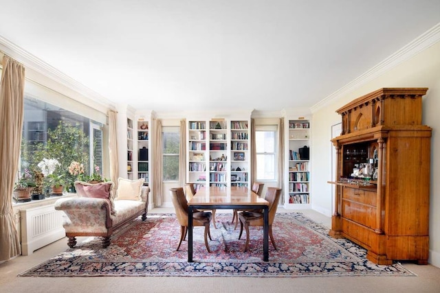 carpeted dining space featuring ornamental molding