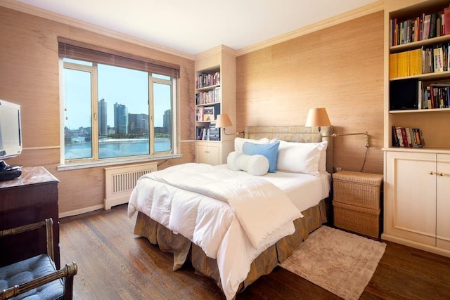 bedroom with crown molding, radiator heating unit, and dark hardwood / wood-style flooring