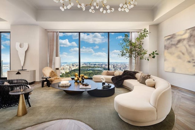 living room featuring crown molding, a notable chandelier, and a raised ceiling