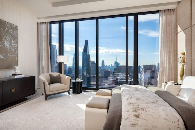 carpeted bedroom with multiple windows and a city view